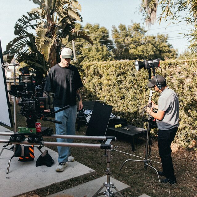 A camera crew setting up lights and rigs on location